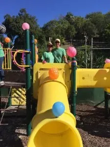 Dr. Kurt Jensen and Mrs. Sue Jensen above the playground slide they help build!